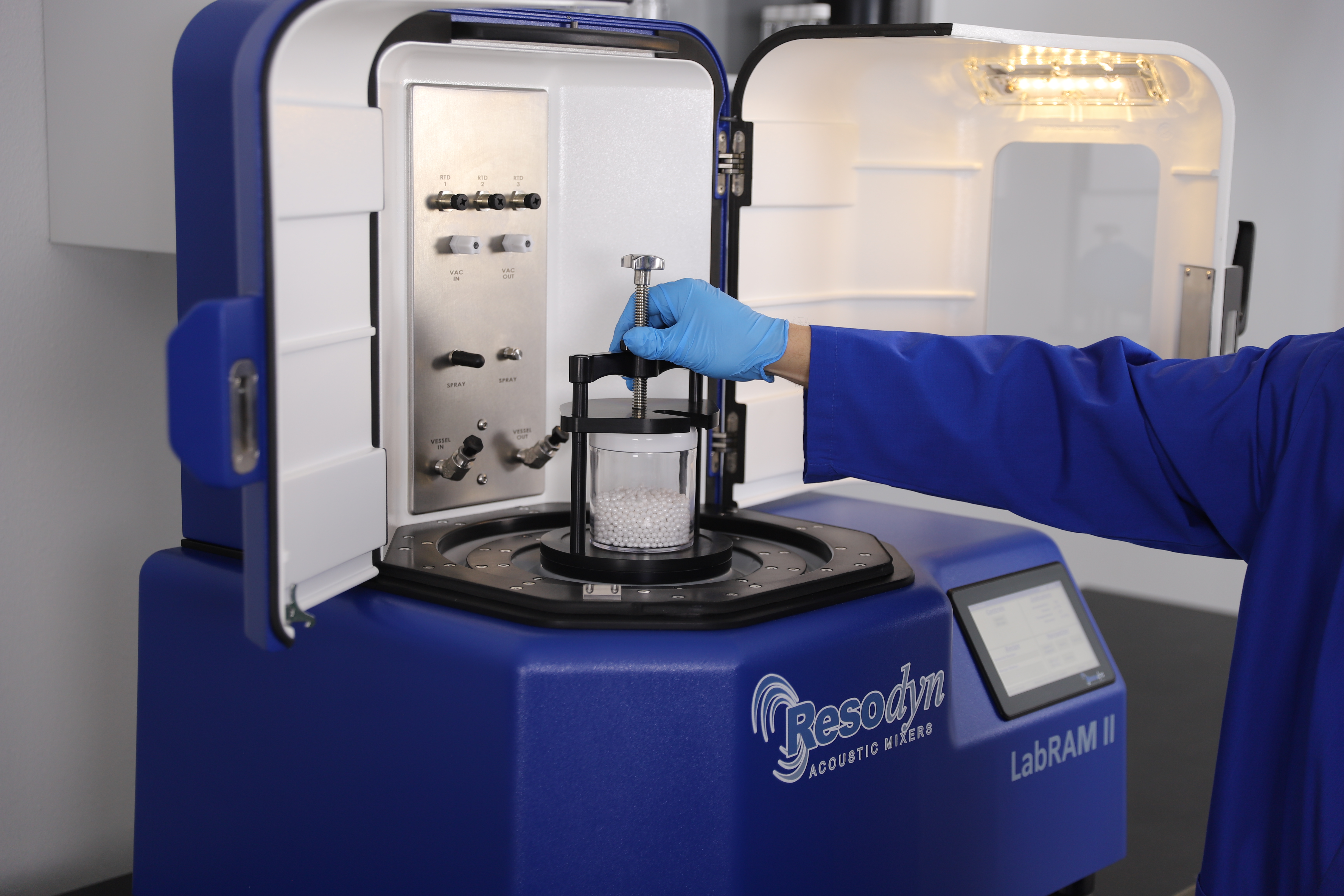 A user adjusts the lock system on a LabRAM II loaded for milling.